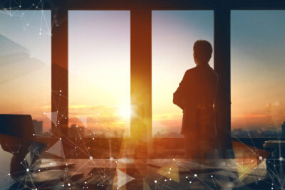 business-leader-standing-near-window-in-office